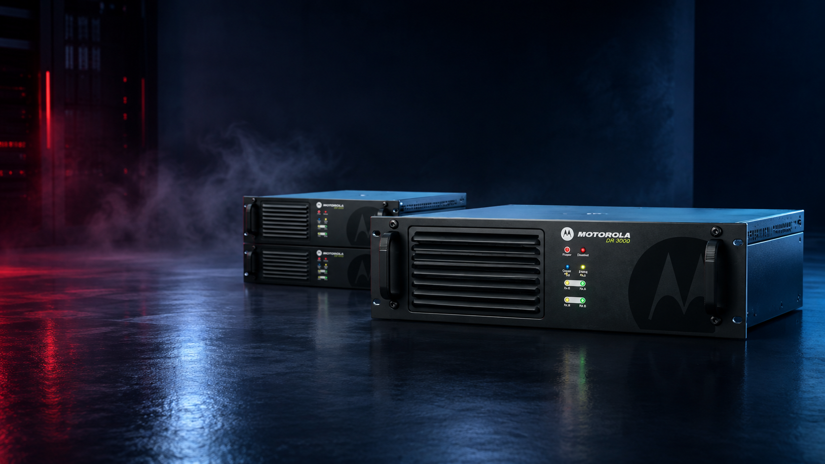 Two black Motorola power distribution units in a dark, atmospheric studio setting with blue reflections and red ambient lighting.