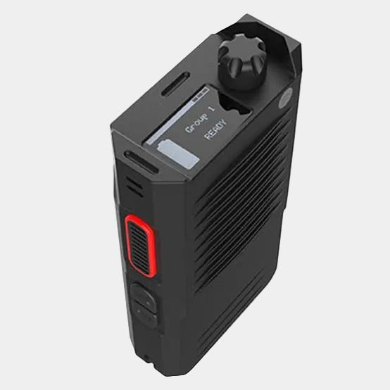 A black handheld electronic device with a textured ribbed body, a red accent panel, and a small display screen, shown on a plain white background.