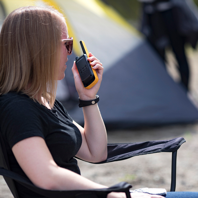 Woman camping and using the Motorola T82